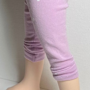 May include: Purple leggings with white polka dots. The leggings are made of a soft, stretchy material and have a cuffed hem.