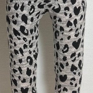 May include: Grey and black leggings with a leopard print pattern.
