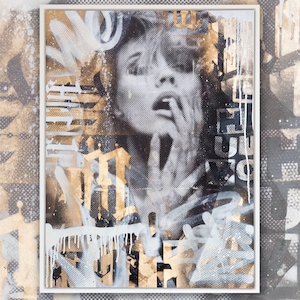May include: A black and white portrait of a woman with gold and white paint splatters and drips. The woman's mouth is open and she is touching her chin with her fingers. The background is a black and white pattern.