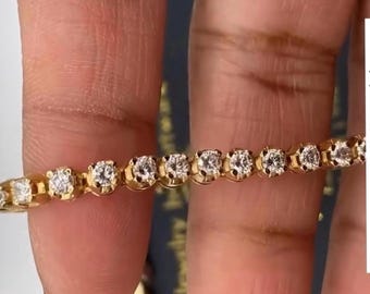 May include: A gold chain bracelet with small round diamonds set in a pave setting.