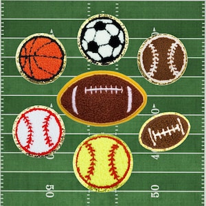 May include: Seven felt patches of different sports balls on a green field. The balls are a soccer ball, basketball, baseball, softball, and two footballs. The patches are all gold with a black outline.