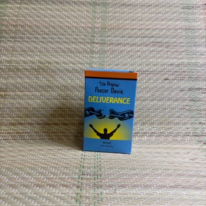 May include: A blue soap box with orange and white text that reads "The Original Pastor Davis Deliverance". The box features a graphic of a person with arms raised and broken chains. The word "SOAP" is printed at the bottom.