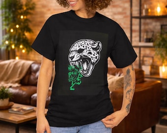 May include: Black t-shirt featuring a detailed black and white illustration of a snarling leopard's head. The design includes green text that reads "Have Great Rules". The model is wearing blue jeans.