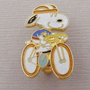Vintage Aviva Snoopy Pin Riding a Bike in Blue Shirt 1030