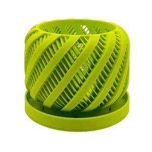 May include: A bright green plastic planter with a unique, geometric design. The planter has a round base and a cylindrical, open-top design with a lattice-like pattern.