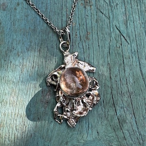 Unusual ooak sterling silver pendant featuring a large natural topaz oval cabochon.