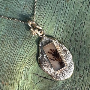 Unusual ooak sterling silver pendant featuring a long dendritic agate cabochon with plant like pattern.