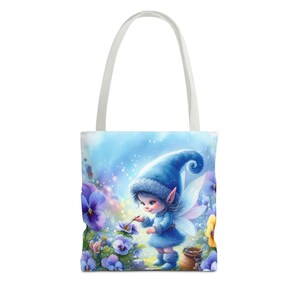 May include: A blue fairy with wings and a pointed hat is painting a purple flower. The fairy is surrounded by purple flowers and a blue sky with white clouds. The tote bag is white with a blue handle.