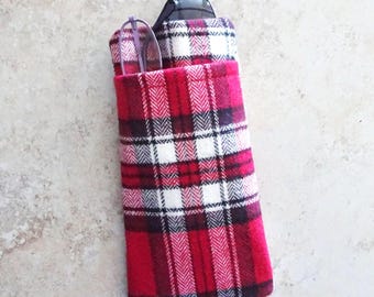 May include: A rectangular glasses case in a red, white, and black plaid pattern. The case contains a pair of glasses. The case is made of fabric and is designed to protect spectacles and sunglasses.