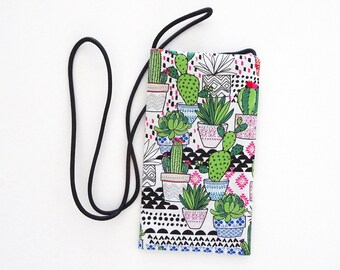 May include: A rectangular phone case with a black cord. The case features a white background with a repeating pattern of potted cacti and succulents in various colours and designs. The case is approximately 15 cm tall.