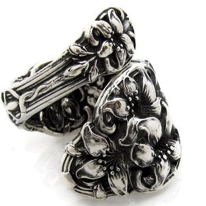 May include: A silver ring made from a vintage spoon, featuring a floral design with intricate details.