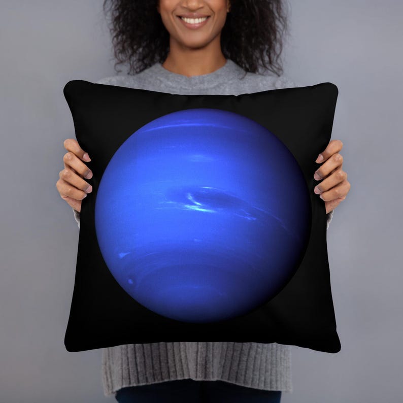 May include: A square throw pillow featuring a deep blue, spherical depiction of the planet Neptune centered against a solid black background. The planet graphic displays subtle variations in blue tones and cloud-like atmospheric bands.