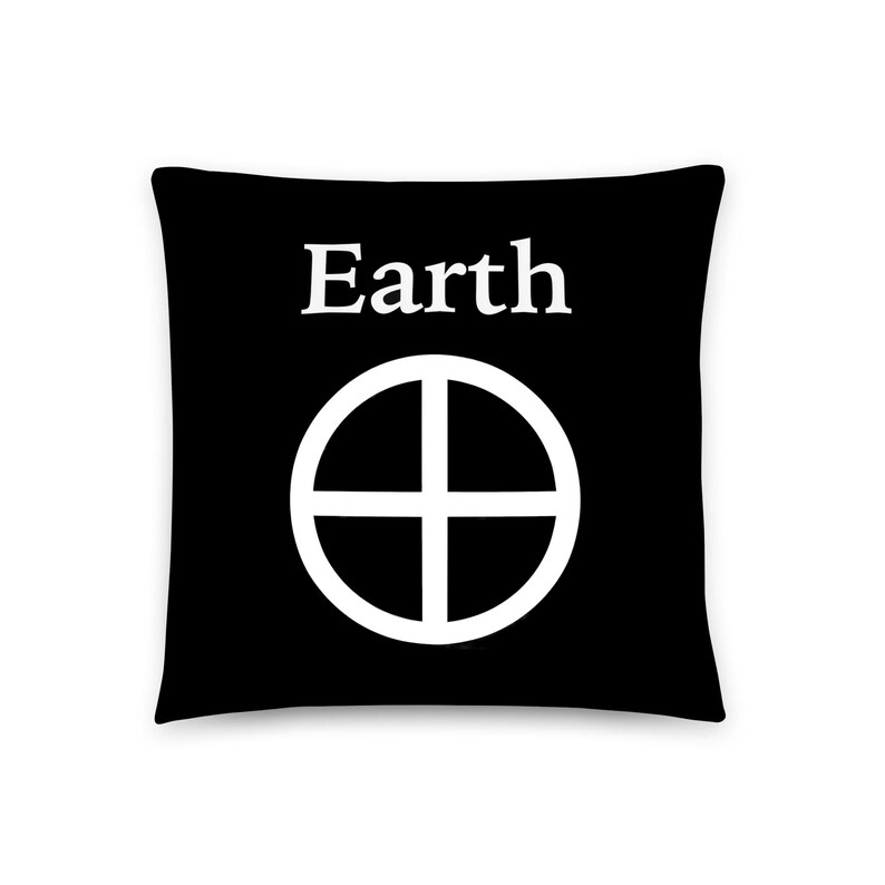 May include: A square black throw pillow featuring the white text Earth centered at the top, positioned above a white circular symbol containing a cross, which divides the circle into four equal quadrants against the solid black background.