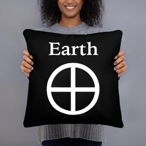 May include: A square black throw pillow featuring the white text Earth centered at the top, positioned above a white circular symbol containing a cross that divides the circle into four equal quadrants, creating a bold high-contrast design.