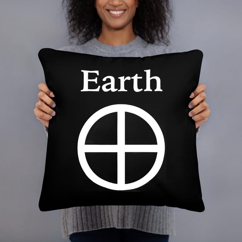 May include: A square black throw pillow featuring the white text Earth centered at the top, positioned above a white circular symbol containing a cross that divides the circle into four equal quadrants, creating a bold high-contrast design.