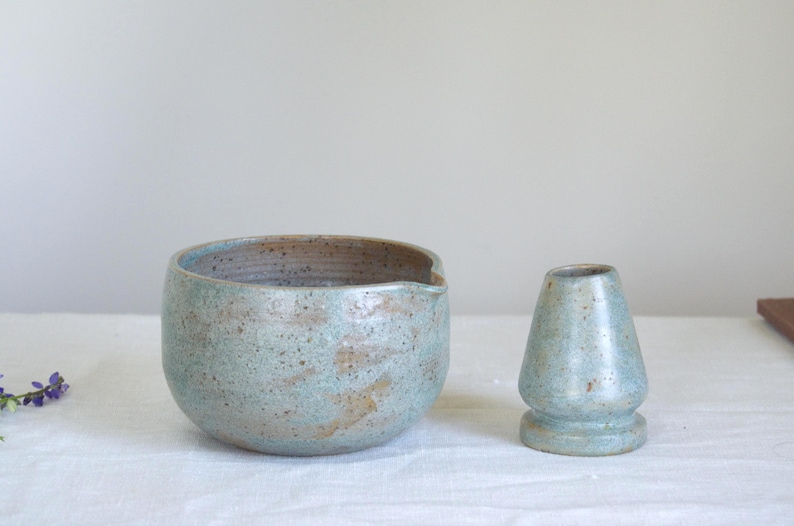 Matcha set with matte teal bowl styled with floral details and bamboo mat. Ideal for those who seek intentional rituals and love surrounding themselves with handmade pieces and calm textures.