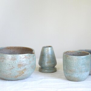 Large handmade matcha bowl in rich teal glaze shown in use with bamboo tools. Designed for slow tea rituals, healthy living and those who enjoy a deeper, grounding matcha experience.