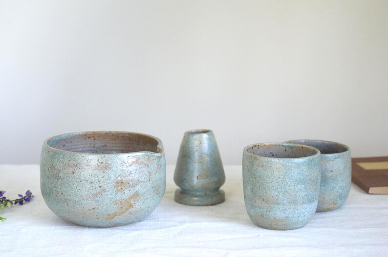 Large handmade matcha bowl in rich teal glaze shown in use with bamboo tools. Designed for slow tea rituals, healthy living and those who enjoy a deeper, grounding matcha experience.