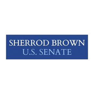 May include: A rectangular blue sign with the text "SHERROD BROWN" in white capital letters above "U.S. SENATE" in light blue capital letters.