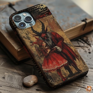 May include: A phone case featuring a vintage illustration of a red devil-like figure embracing a girl in a red dress. The case has a distressed, antique look with a textured background and a dark border. The design evokes a gothic or fantasy theme.