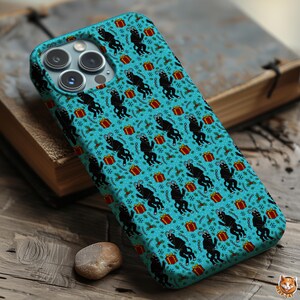 May include: A teal phone case featuring a repeating pattern of black goat silhouettes, red gift boxes, and festive holiday accents. The case is designed to fit a smartphone and offers protection with a unique, seasonal design.