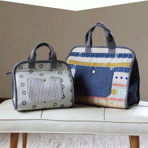 May include: Two tote bags, one gray and white with a striped pocket and the other blue, white, and yellow with a blue pocket. The bags are sitting on a white bench with wooden legs. The text "MAKER'S TOTE" is at the top of the image and "noodlehead #538" is at the bottom.