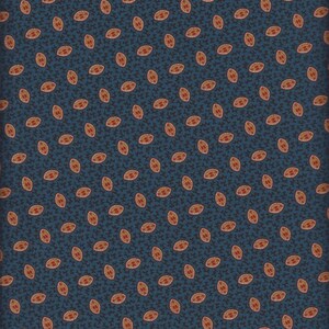 May include: A blue fabric with a repeating pattern of small, oval-shaped designs in shades of brown and red.