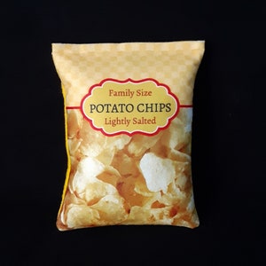 May include: A yellow bag with a checkered pattern and the words "Family Size Potato Chips Lightly Salted" printed on it. The bag is filled with potato chips.