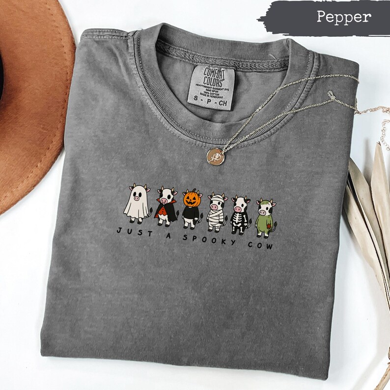 Gray t-shirt with "Just a Spooky Cow" text and Halloween-themed cows.