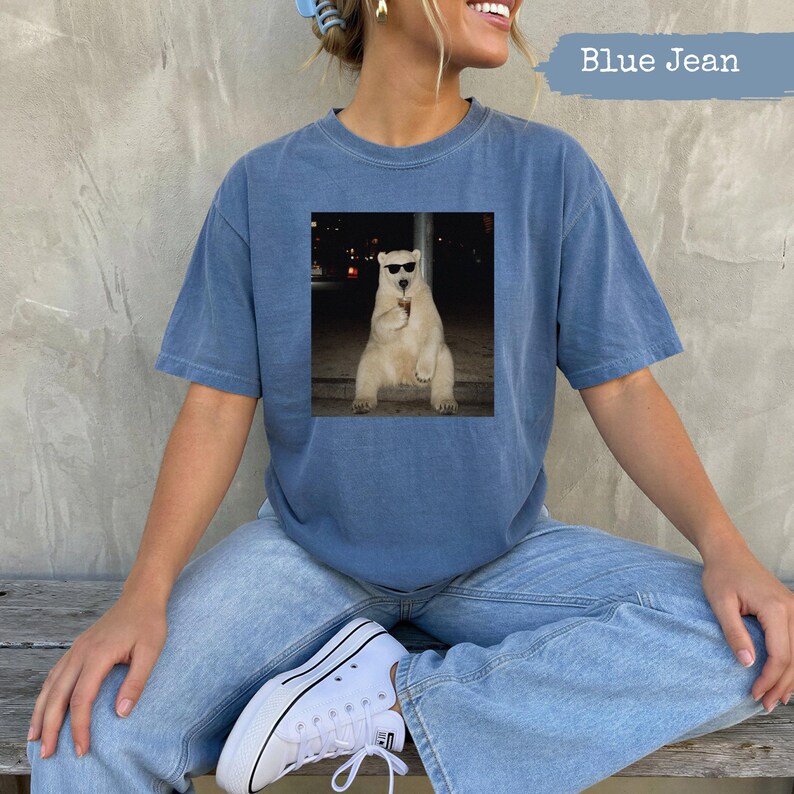Polar bear in sunglasses holding a drink on a t-shirt.