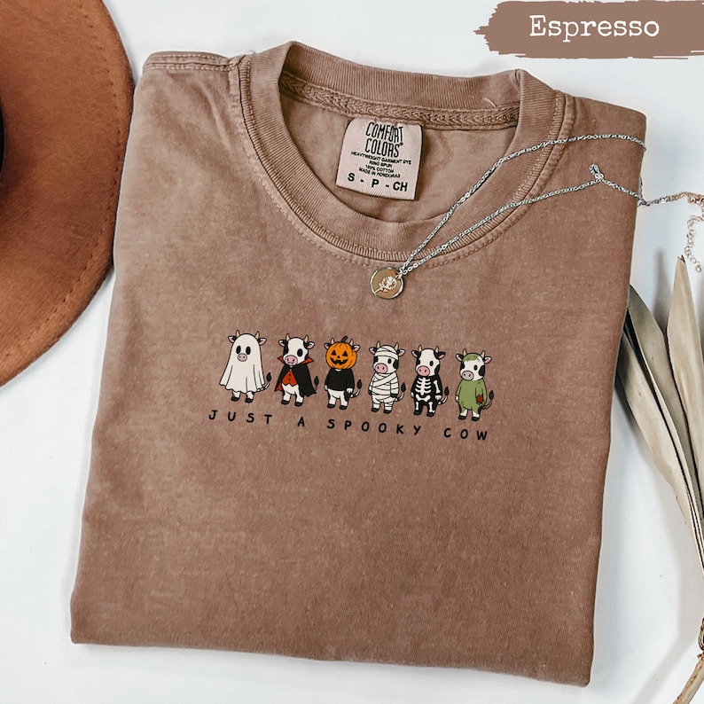 Brown Comfort Colors t-shirt with "Just A Spooky Cow" Halloween cows graphic.
