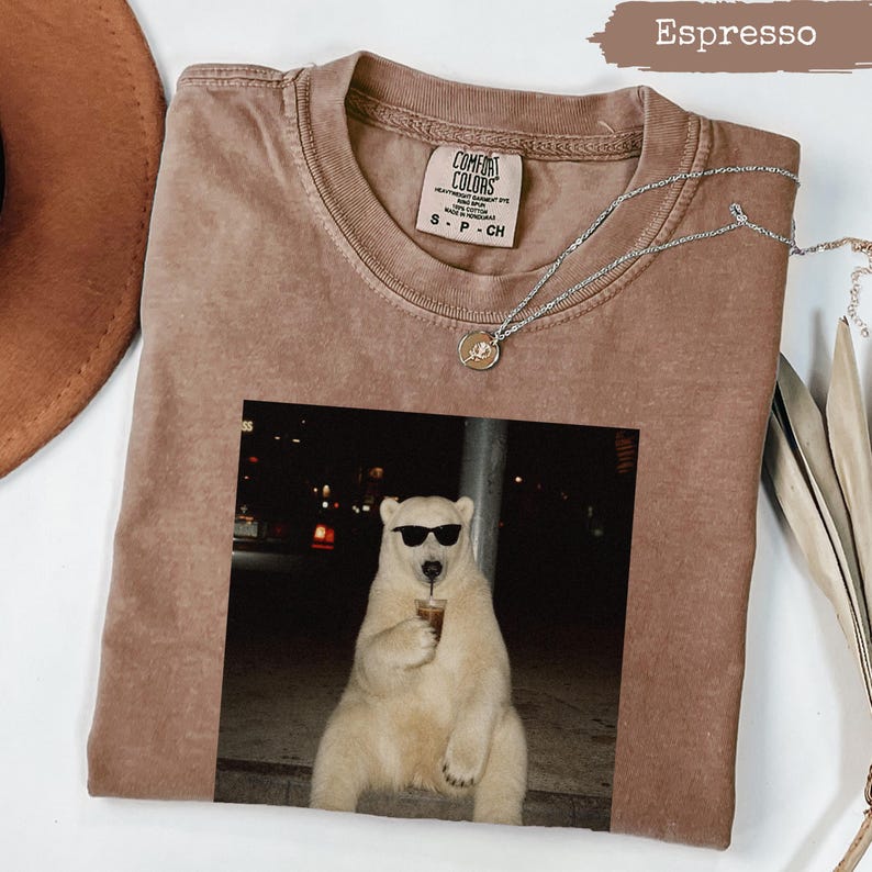 Brown Comfort Colors t-shirt with polar bear wearing sunglasses drinking coffee.