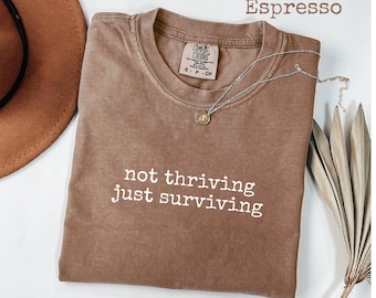 Comfort Colors® Not Thriving Just Surviving Graphic T-Shirt, Funny Real Life Quote Tee, Relatable Exhausted Girl Gift for Her, Women's Tee