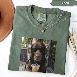 Green t-shirt with graphic of a dog drinking coffee; "Coffee Good Days & Labs" text.