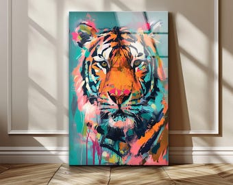 May include: A vibrant, colorful painting of a tiger's face. The artwork features bold brushstrokes in shades of orange, teal, pink, and black. The tiger's eyes are a focal point, and the painting is displayed against a white wall and wooden floor.