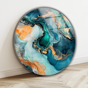 May include: Round wall art with an abstract design. The artwork features swirling patterns in shades of teal, turquoise, orange, and gold. The piece has a glossy finish and is mounted on a white wall.