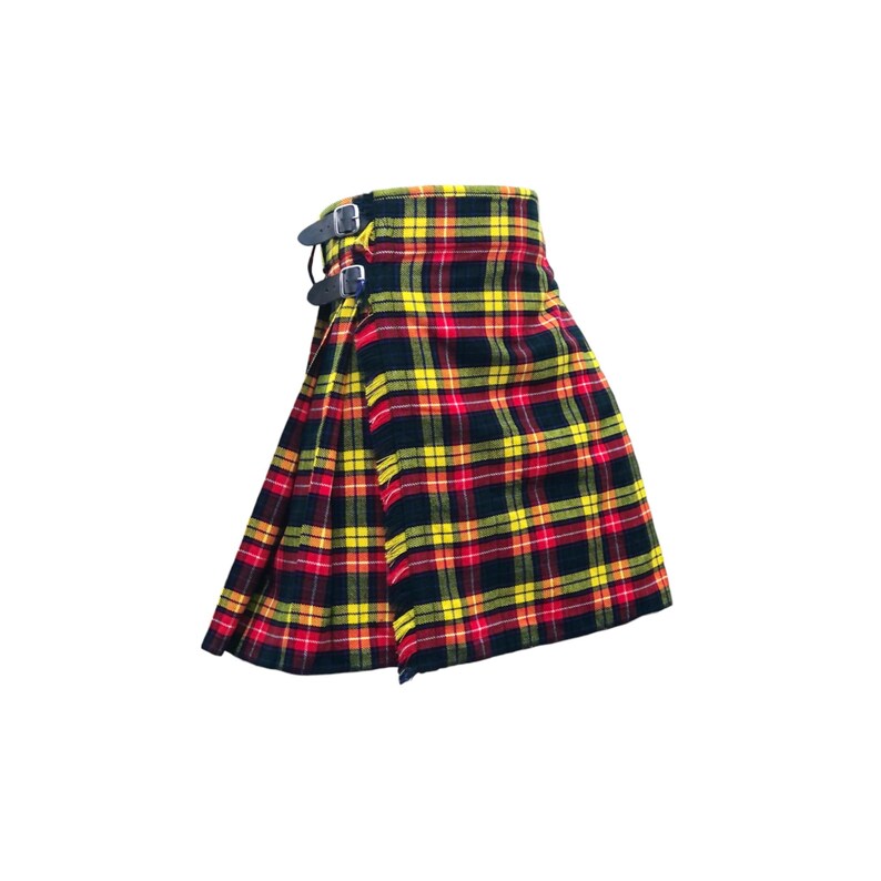 May include: A traditional Scottish kilt in a vibrant tartan pattern of red, yellow, and black. The kilt features leather straps with silver buckles for closure. The pleated design is visible, showcasing the fabric's woven texture.
