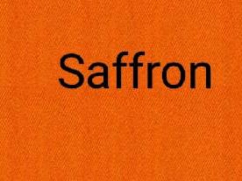 May include: Close-up of a textured, saffron-colored fabric. The word "Saffron" is printed in black, centered on the fabric. The fabric's weave is visible, adding depth to the image.