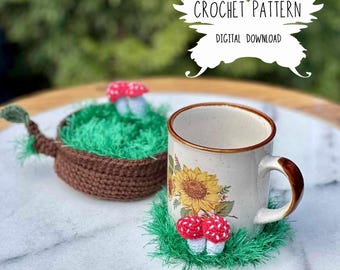 May include: Crochet pattern for a mushroom-shaped coaster. The coaster is brown with green grass and a red and white mushroom on top. The pattern is a digital download.