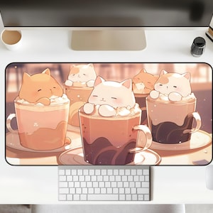 May include: A colorful mousepad with a design of four cartoon cats in mugs of hot chocolate with whipped cream. The cats are orange, white, and brown.