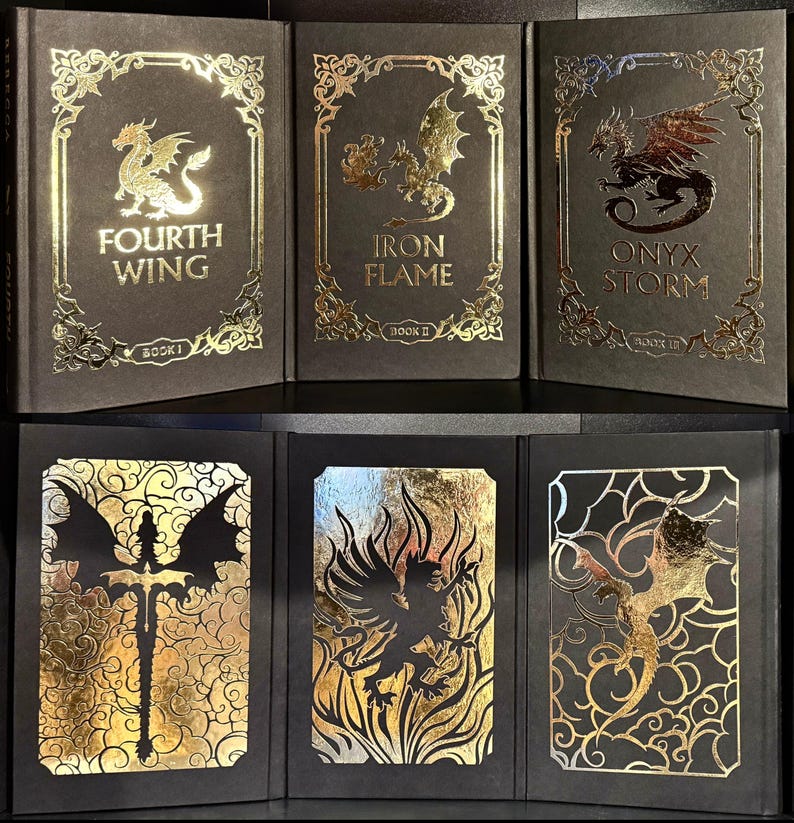 May include: Three black hardcover books with gold foil accents. The books are titled "Fourth Wing", "Iron Flame", and "Onyx Storm". The books are part of a series and are numbered 1, 2, and 3 respectively.