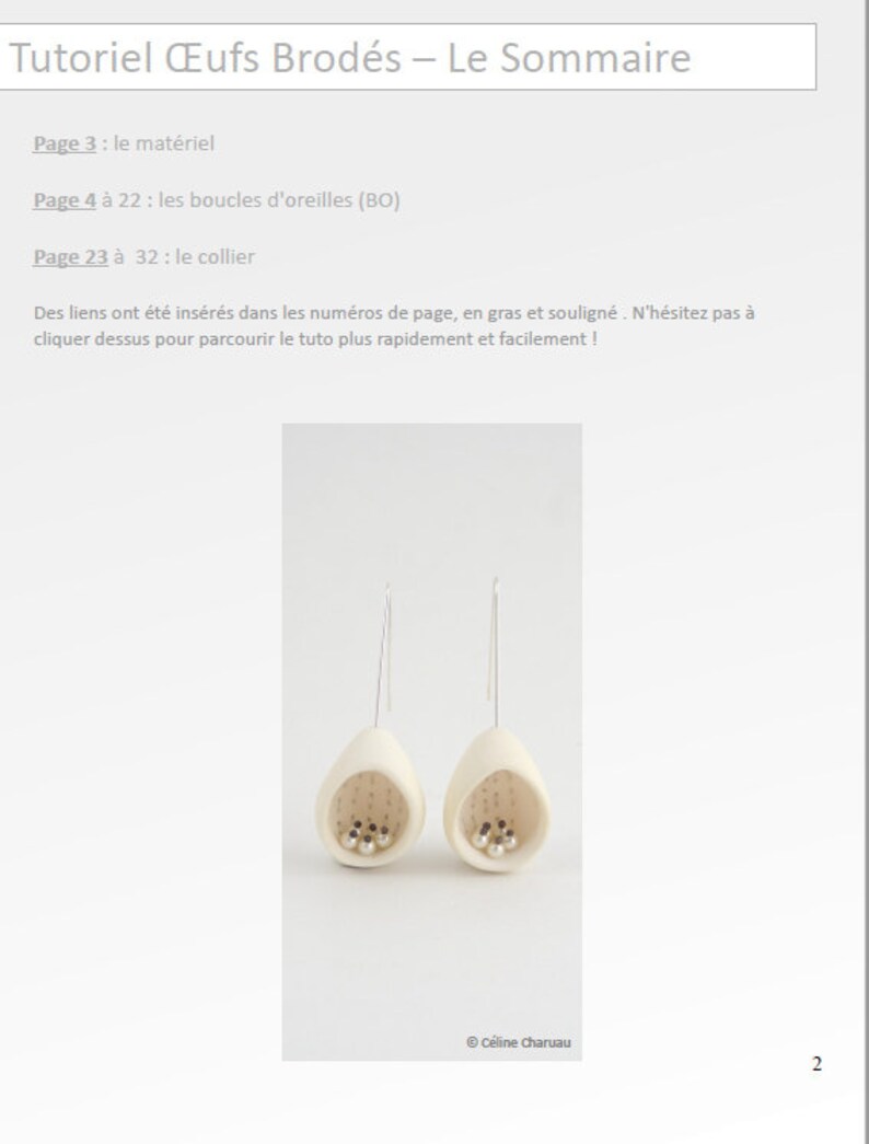May include: A pair of white ceramic earrings with a small hole in the bottom and a silver wire hanging from the hole. The earrings are shaped like an egg and have a small cluster of silver beads inside. The earrings are hanging against a white background.