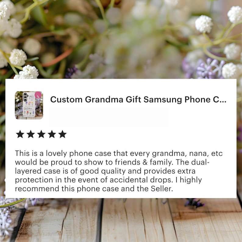 May include: A Samsung phone case with a floral design and the text "Custom Grandma Gift." The case is dual-layered for extra protection. The background features flowers and a wooden surface.