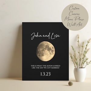May include: A black canvas print with a photo of the moon and the text "John and Lisa" and "This is what the moon looked like the day we got married 1.3.23".