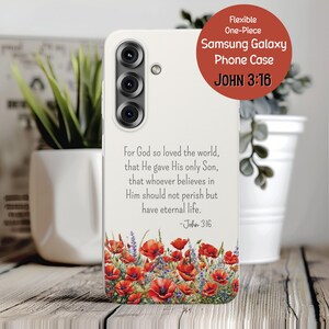 May include: A white Samsung Galaxy phone case with a floral design featuring red poppies and purple flowers. The case includes the text "For God so loved the world..." and "John 3:16". The case is flexible and one-piece.