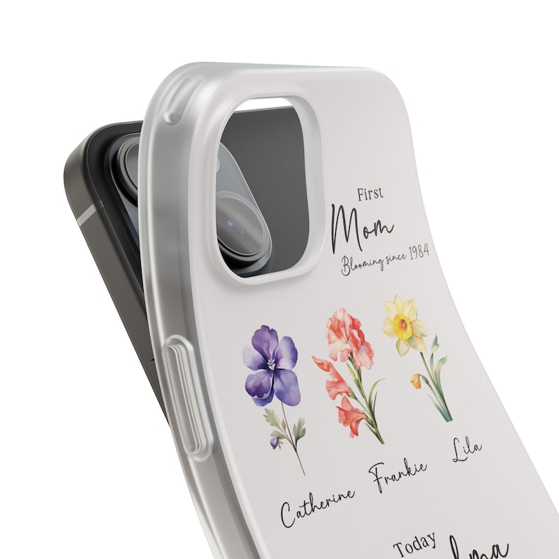 May include: A white phone case with a floral design and the text "First Mom Blooming since 1984". The flowers are purple, orange, and yellow. The names Catherine, Frankie, and Lila are written below the flowers.