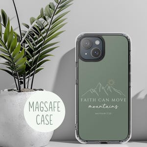 May include: A clear phone case with a green background and a white outline of mountains and a sun. The text "FAITH CAN MOVE mountains" and "MATTHEW 17:20" is printed on the case.