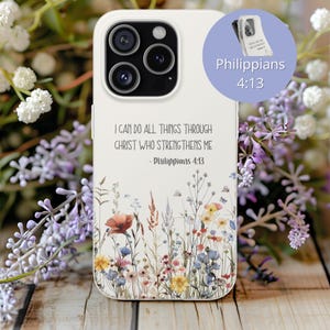 May include: White phone case with a floral design featuring red, yellow, and blue flowers. The case has the text "I CAN DO ALL THINGS THROUGH CHRIST WHO STRENGTHENS ME - Philippians 4:13". A small circle shows the text "Philippians 4:13".