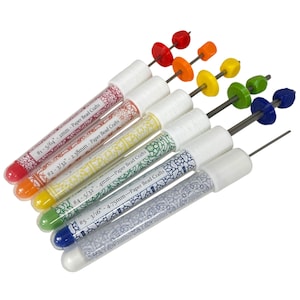 May include: A set of paper bead craft tools. Each tool has a clear tube with a white cap and a label with measurements. The tools are arranged in a rainbow of colors, with beads on metal rods. The text on the tubes reads "Paper Bead Crafts".