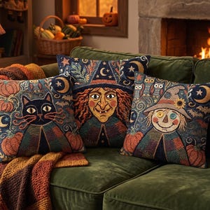 May include: Three square throw pillows featuring intricate tapestry-style embroidery. One pillow depicts a black cat, another a witch with a pointed hat, and the third a scarecrow with button eyes, all surrounded by pumpkins, stars, and moons.